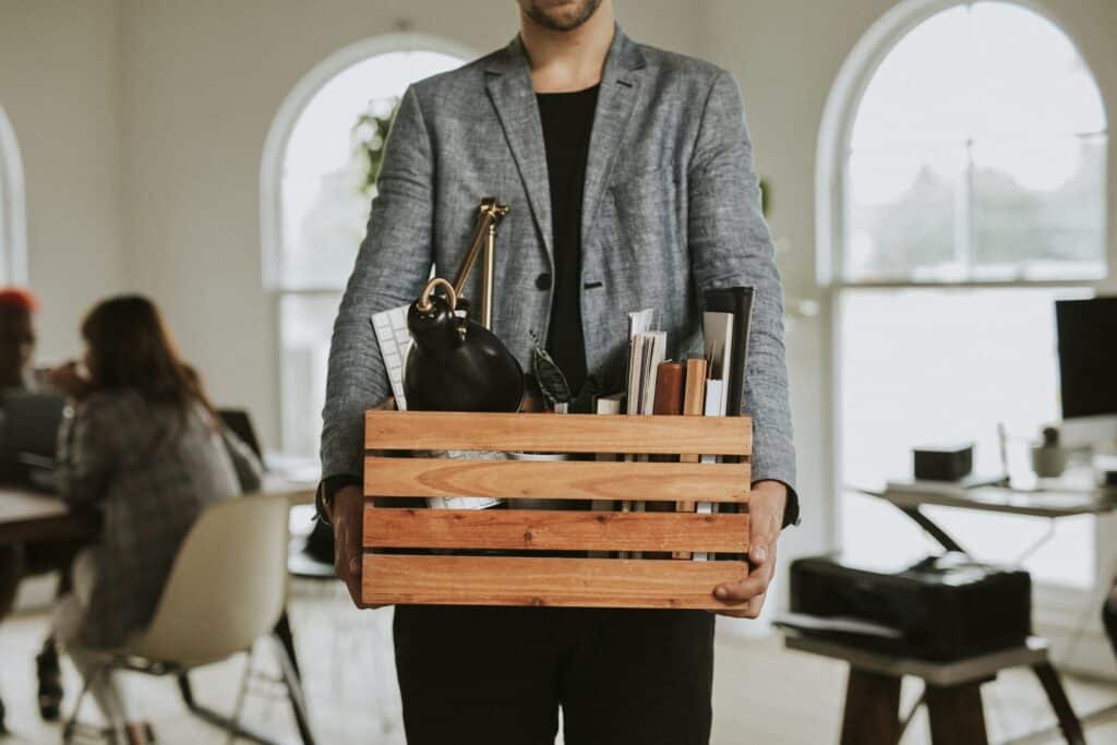 Man carrying a wooden box in the office